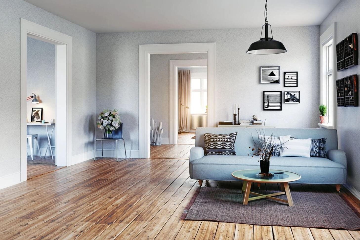 A living room with hard wood floors and white walls.